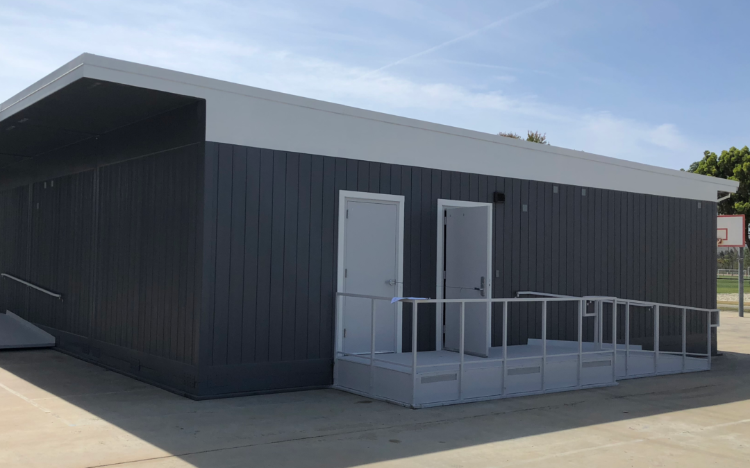 Black and white modular restrooms with ramps and multiple entrances